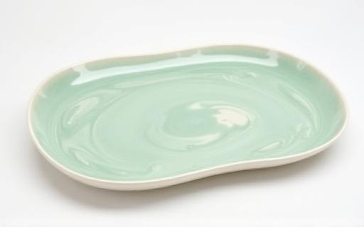 Large oval ceramic serving platter with unique glaze pattern
